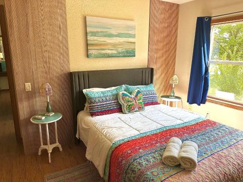 a bedroom with a bed with a butterfly pillow on it at Legacy Lakehouse in Spicer