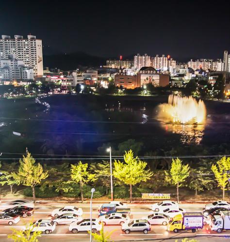 a parking lot with cars parked in a parking lot at Boutique Hotel Wine in Gwangju