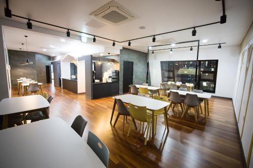 a restaurant with tables and chairs in a room at Boutique Hotel Wine in Gwangju