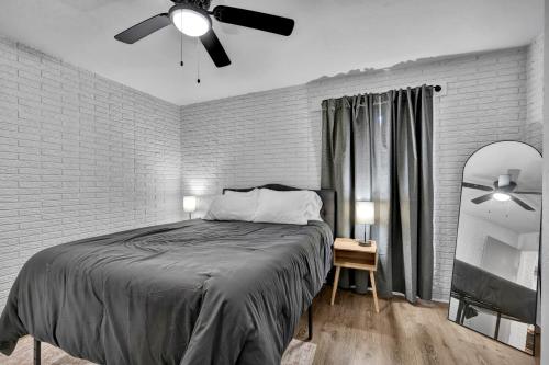 a bedroom with a bed and a ceiling fan at Near Boomer Lake & OSU - Relaxing Retreat in Stillwater