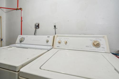 two washing machines sitting next to each other in a room at Cozy two bedroom one bath in Cleveland