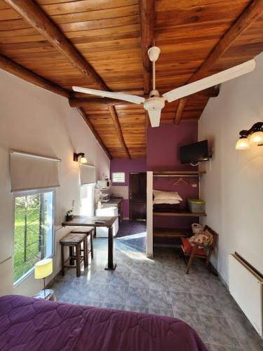 a bedroom with a bed and a desk and a ceiling at El Zohar 2 pax in Federación