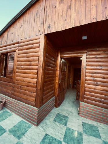 an outside view of a wooden building at Cabañas El Zonda in Tinogasta
