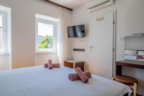 a bedroom with a bed and a tv on the wall at Villa Sea Valley in Crikvenica