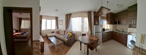 a kitchen and living room with a couch and a table at Апартаменты в Belvedere in Bansko