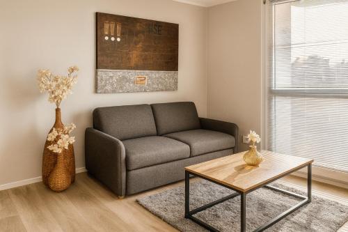 a living room with a couch and a table at Twenty2 Apartments in Brühl