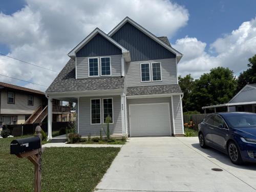 a house with a car parked in the driveway at Work and play close to everything in Frederick