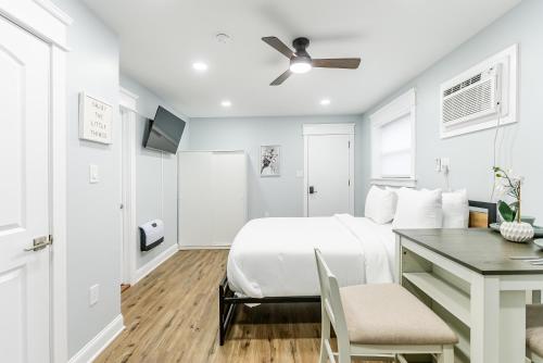 a white bedroom with a bed and a desk at Studio Minutes from Center City South Philly Special in Philadelphia