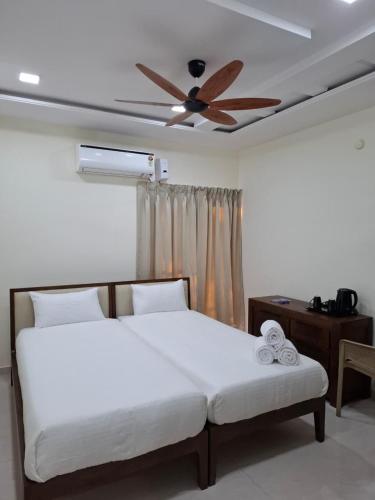 a bedroom with a bed with a ceiling fan at Farm Stay Genome in Jāmb