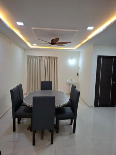 a dining room with a table and chairs and a ceiling at Farm Stay Genome in Jāmb