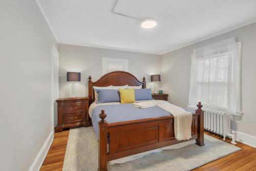 a bedroom with a bed with blue and yellow pillows at The Game House Arcade West Hartford in West Hartford