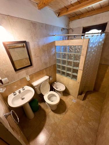 a bathroom with a toilet and a sink at La Maru in Villa Giardino