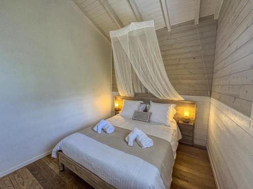 a bedroom with a bed with two towels on it at Blue Horizon in Vieux-Habitants
