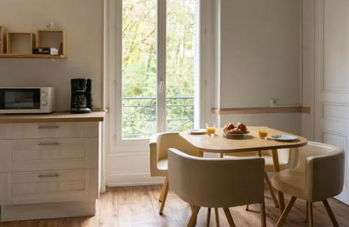 a kitchen with a table with a bowl of fruit on it at Sable Aix in Aix-les-Bains