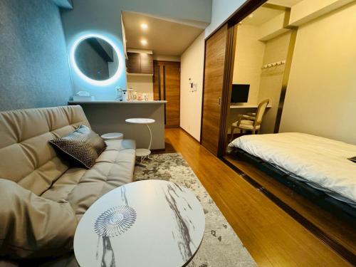 a living room with a couch and a bed at LuxurySweet 博多駅南61 in Fukuoka