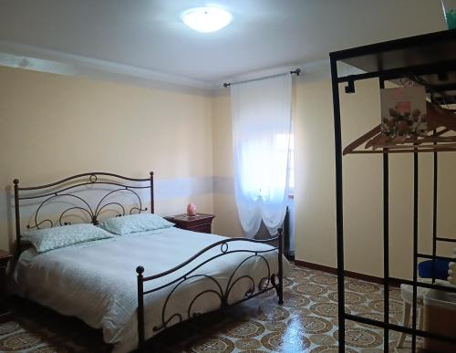 a bedroom with a large bed and a window at Il Sentiero beb in Verona