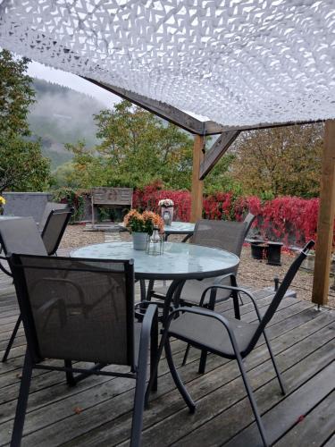 a table and chairs on a wooden deck at Weingut Fehres in Brauneberg