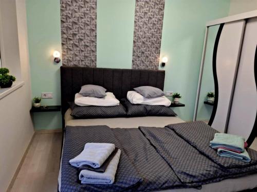 two beds in a small room with towels on them at Sweethome12 in Fonyód