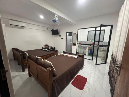 a bedroom with two beds and a tv and a mirror at David Villa in Anuradhapura
