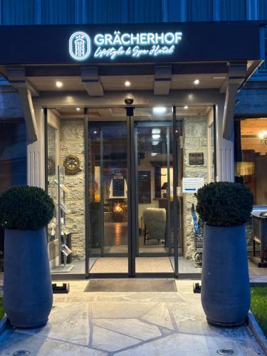 a front door of a building with a sign on it at Lifestyle & Spa Hotel Grächerhof in Grächen