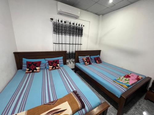 two twin beds in a room with at David Villa in Anuradhapura