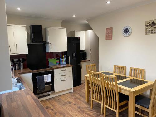 a kitchen and dining room with a table and chairs at Johaan in Caernarfon