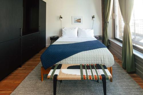 a bedroom with a bed with a blue blanket on it at Loft 302 - The William - Sunlit - Above Carrigans in Birmingham