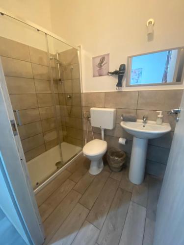 a bathroom with a shower and a toilet and a sink at DAREB HOME vista mare in Agrigento