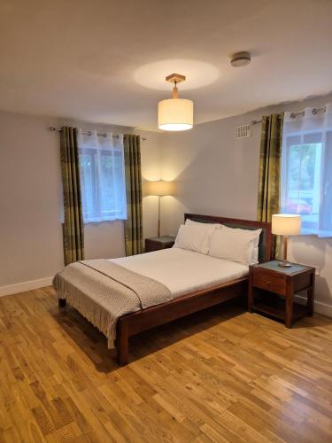a bedroom with a bed and two windows at Annebrook House Hotel in Mullingar