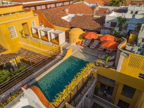 an aerial view of a house with a pool and umbrellas at Casa Carolina Luxury Wellness Hotel in Cartagena de Indias