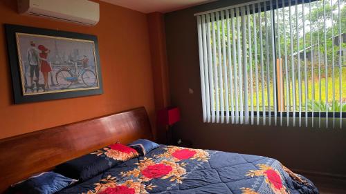 a bedroom with a bed and a window at Villa Mariaclaudia in Macas