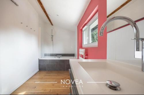 a kitchen with a large sink and a window at L'Écrin des Greens in Dommartin