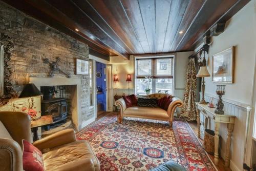 a living room with a couch and a fireplace at Canal Cottage Rodley Leeds, 5 miles LBA Airport in Leeds