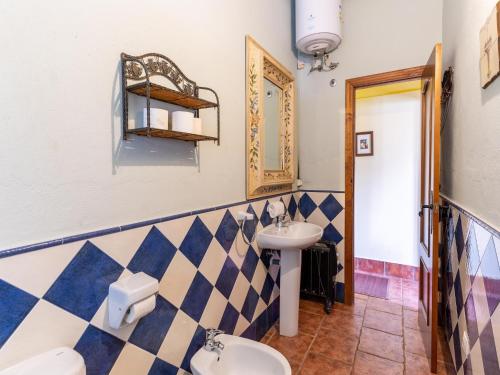 a bathroom with two toilets and a sink at Andalusian Getaway Game of Thrones Castle in Posadas