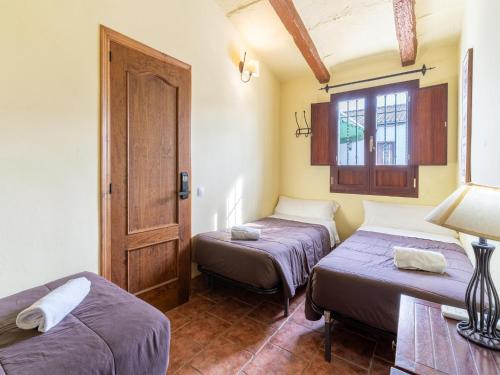 a room with two beds and a window at Andalusian Getaway Game of Thrones Castle in Posadas