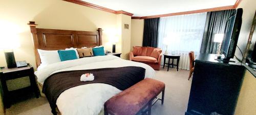 a hotel room with a large bed and a chair at Dav's Slopeside King Studio -- Resort & Spa at Everline in Olympic Valley