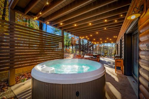 a hot tub on the patio of a house at Merlot Chateau - Views, New Hot Tub, Fire Pit, Game Room, Wi-Fi - Mins to Blue Ridge in Morganton