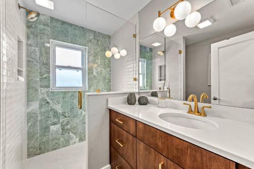 a bathroom with a sink and a mirror at Beach Walk Cottage - 451 in Siesta Key