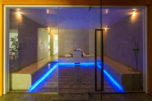 a swimming pool in a house with blue lights at Maison Poluc - Cadeau des Alpes in Champoluc