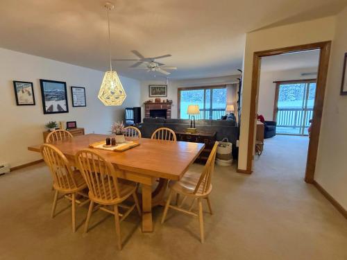 a dining room with a wooden table and chairs at S27 Family style Bretton Woods condo - close to Mt Washington hotel in Cog in Carroll