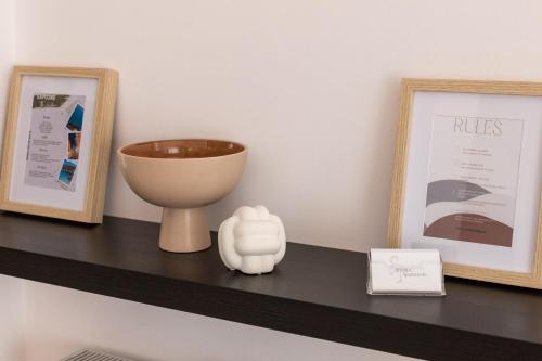 a shelf with a bowl and a bowl on it at Afroditi's Apartment Superb View in Gythio