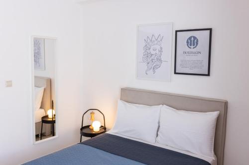 a bedroom with a bed and two pictures on the wall at Afroditi's Apartment Superb View in Gythio
