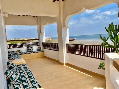 a balcony with a view of the ocean at Mafazy House in Lamu