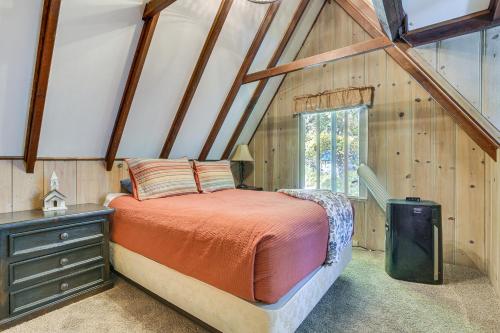 ein Schlafzimmer mit einem Bett und einem Fenster im Dachgeschoss in der Unterkunft Private Dock on Lake Arrowhead! Cozy Mtn Cabin in Lake Arrowhead