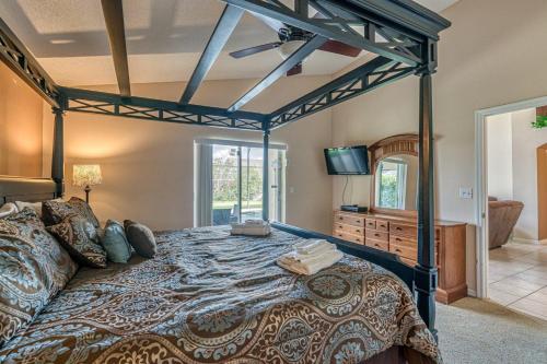 a bedroom with a large bed and a tv at Simba's Lake House in Orlando