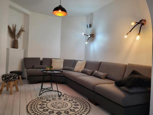 a living room with a couch and a table at Haus de Panne 6 bedrooms in De Panne