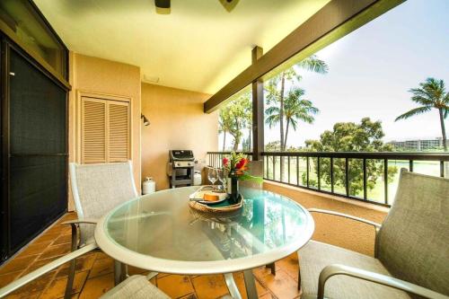 a room with a table and chairs on a balcony at Kaanapali Royal B303 · KRL B303 Relaxing 2BD on Golf Course w Po in Lahaina