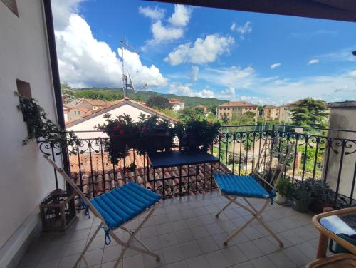 a balcony with two blue chairs and a view at Torre Cà Emo, CasAmarti in Vittorio Veneto