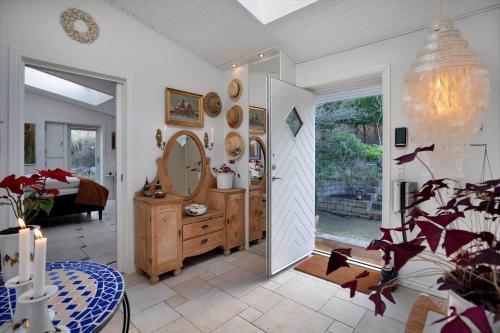 a room with a mirror and a room with a table at 15515-Asnaes-Klintebakken-10 in Høve Strand