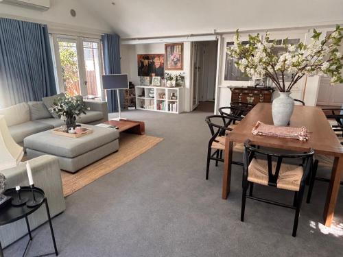 a living room with a couch and a table at Elegant Art Deco Gem Cosy 3BR Retreat in Carnegie